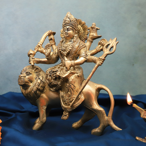 Brass divine Durga statue side view.