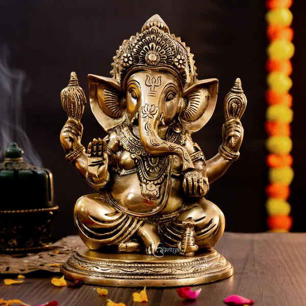 Ganesh idol seated in a blessing posture, holding traditional symbols, with detailed craftsmanship, placed on a wooden surface for home temple décor.