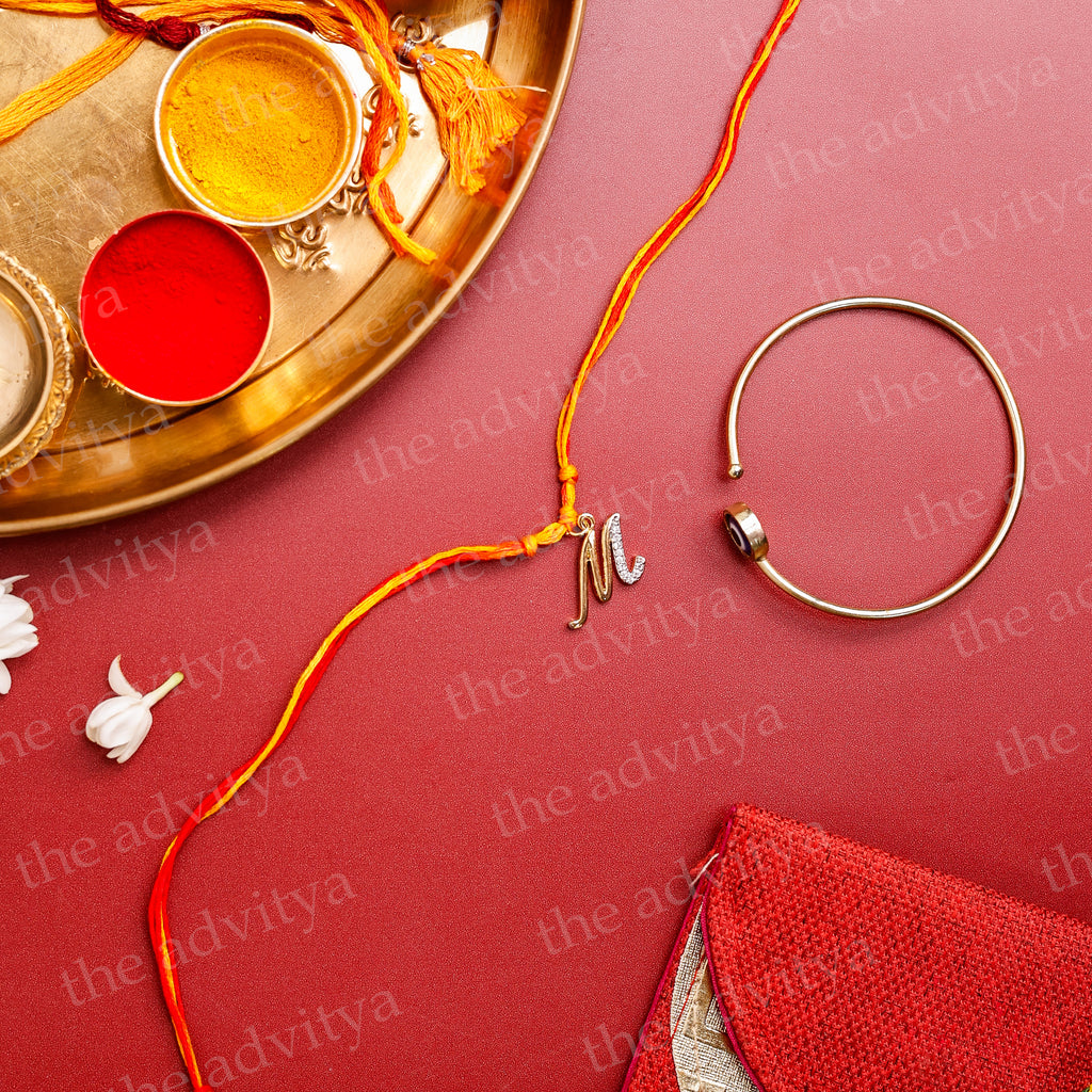 Rakhi,Handmade Rakhi,Rakhi Special Collection,Rakhi gifting , Alphabet M Rakhi Designs in AD Pendant with Golden Evil Eye Bracelet