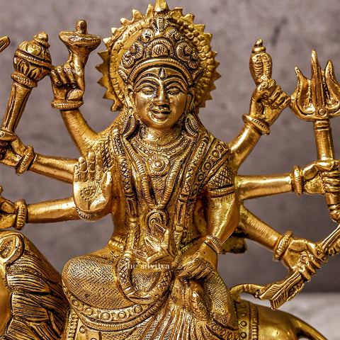 Durga murti with eight hands sitting on a lion, zoom view.