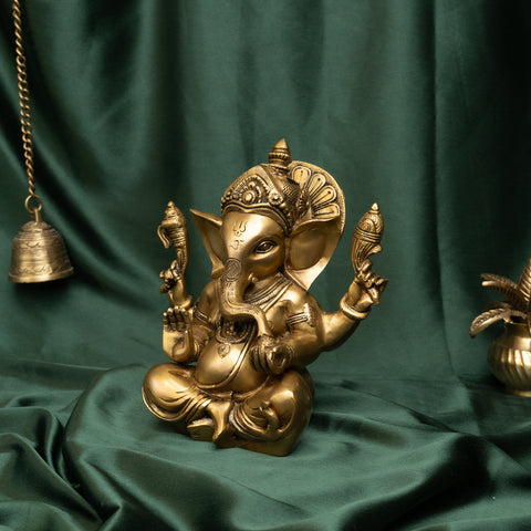 Traditional brass Ganesha murti in seated pose with raised blessing hand