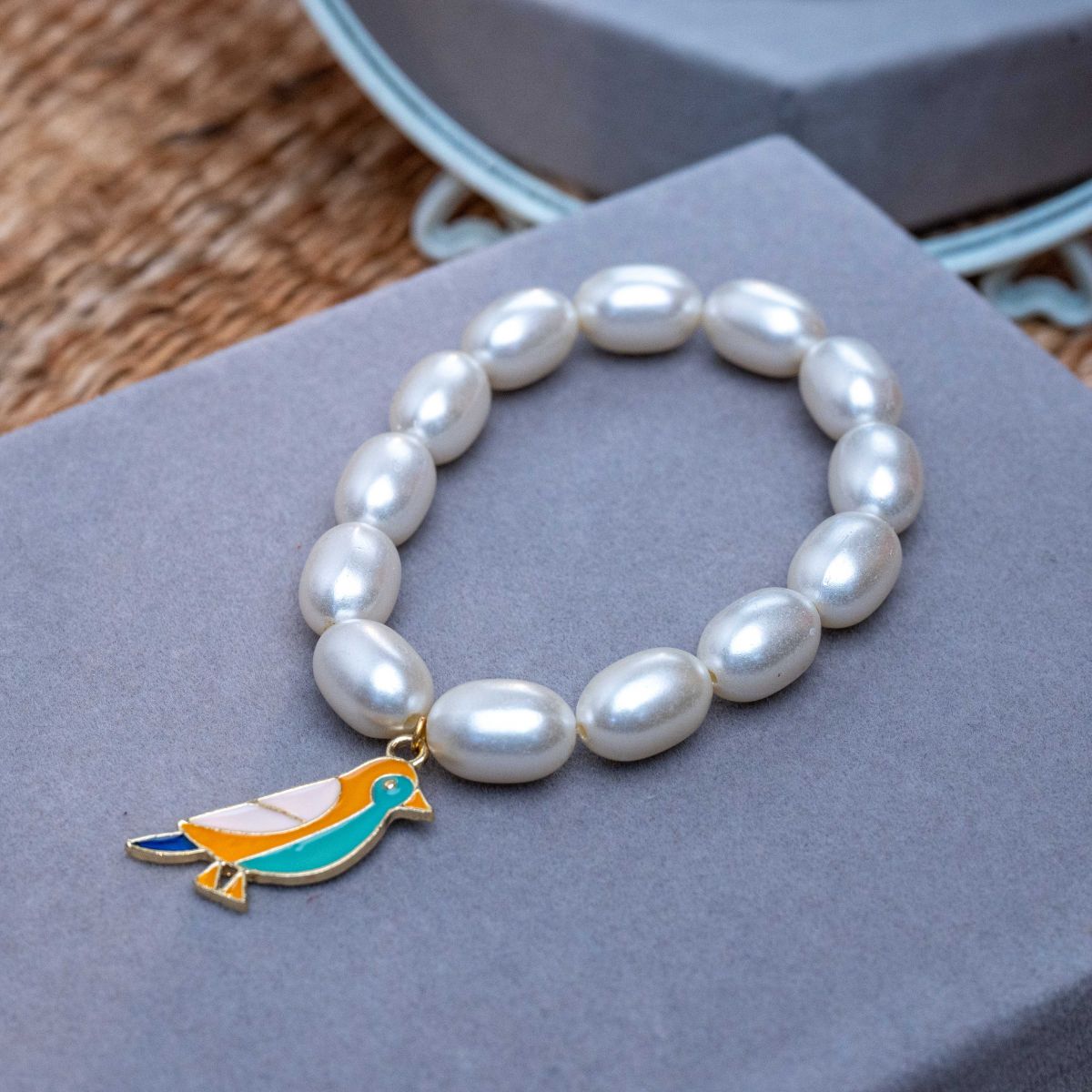 Bird Charm in Pearl Bracelet Rakhi for Sister Roli Chawal