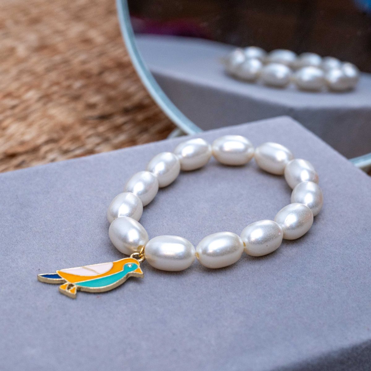 Bird Charm in Pearl Bracelet Rakhi for Sister Roli Chawal