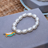 Bird Charm in Pearl Bracelet Rakhi for Sister Roli Chawal
