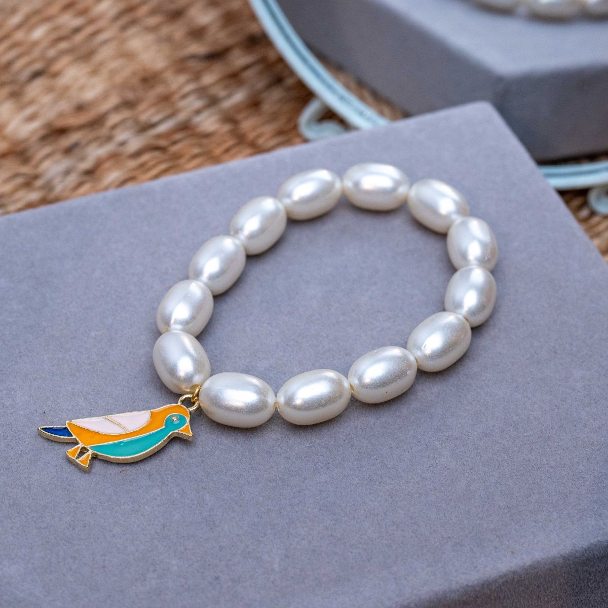 Bird Charm in Pearl Bracelet Rakhi for Sister Roli Chawal