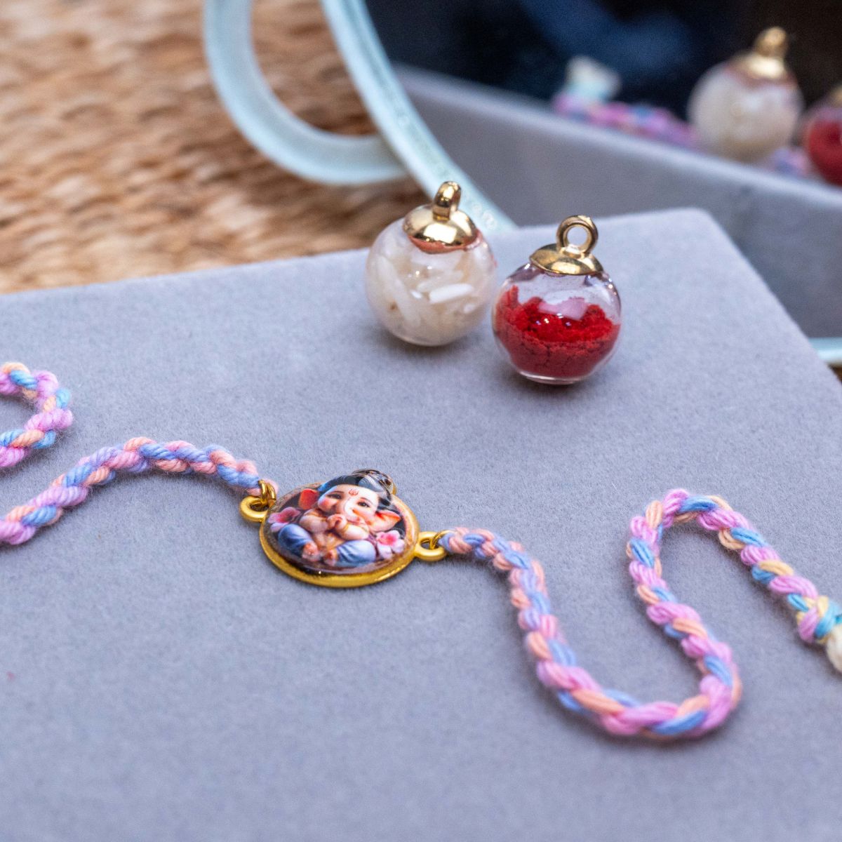 Kids Bal Ganesha Rakhi in Coral & Thread With Roli Chawal