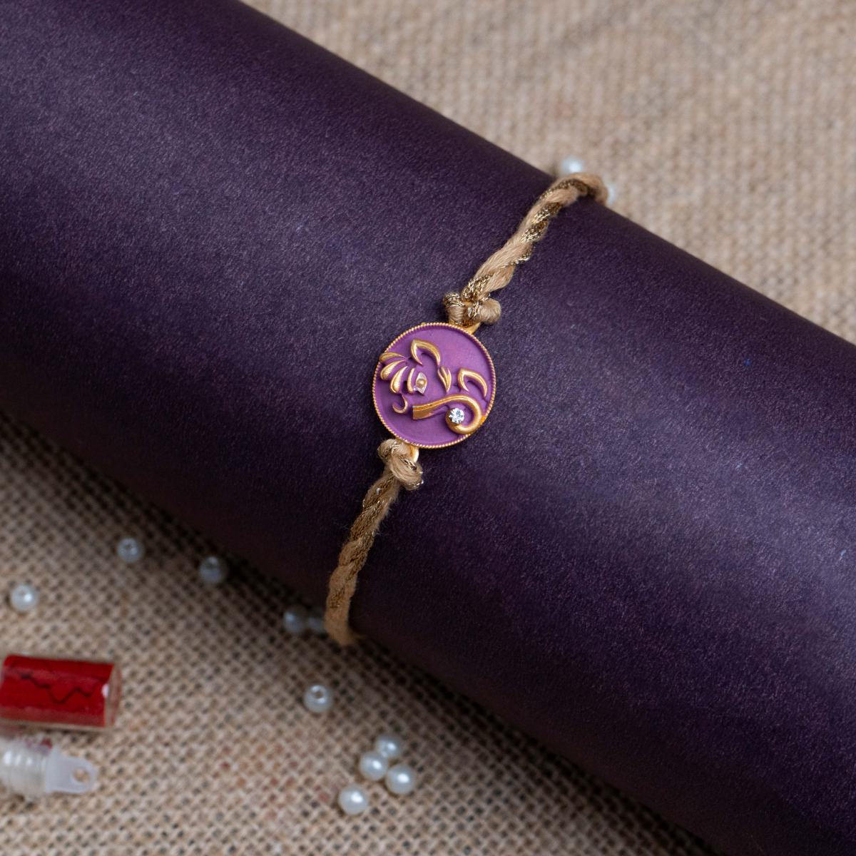 Ganesha Face Rakhi for Brother With Roli Chawal (Purple)