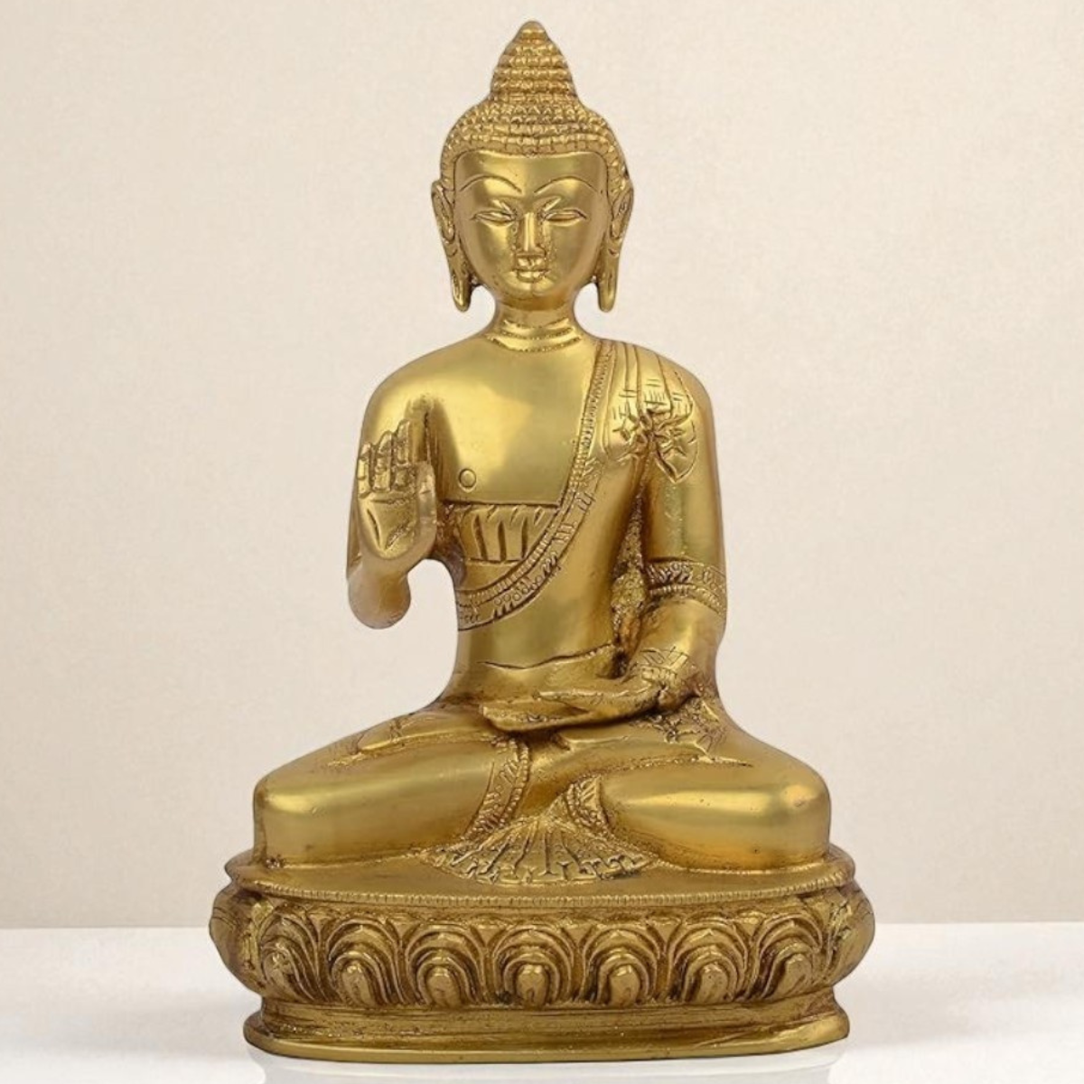 Close-up view of Amitabha Buddha brass statue showcasing intricate facial features, crown detailing, and polished craftsmanship.