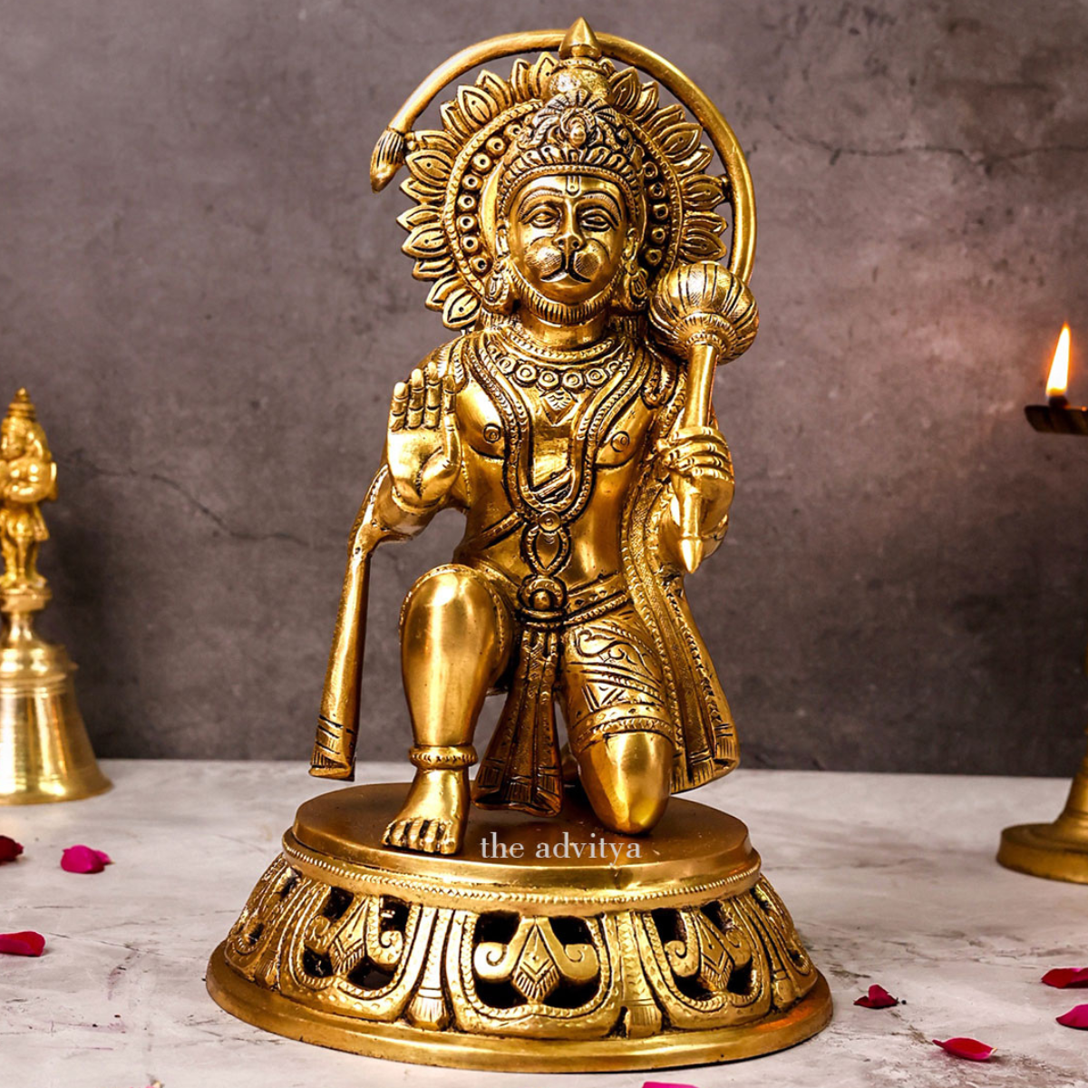 Large brass Hanuman idol in sitting posture with blessing hand, front view.