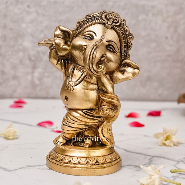 Close-up of Baby Dancing Ganesha Idol highlighting craftsmanship and golden finish