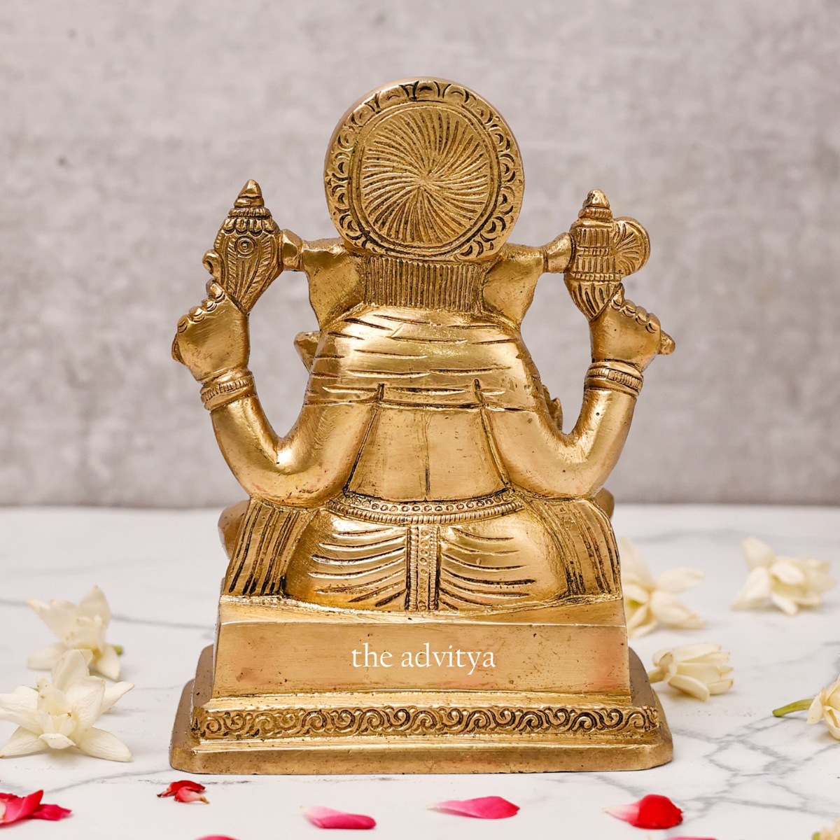 6 inch Brass Ganesh Idol Svarup placed in home temple décor setting, four hands holding Shankh back view