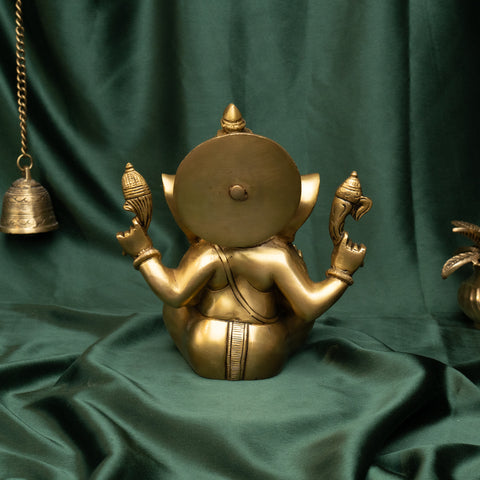 Back view of brass Ganesha statue in sitting posture showing detailed carving