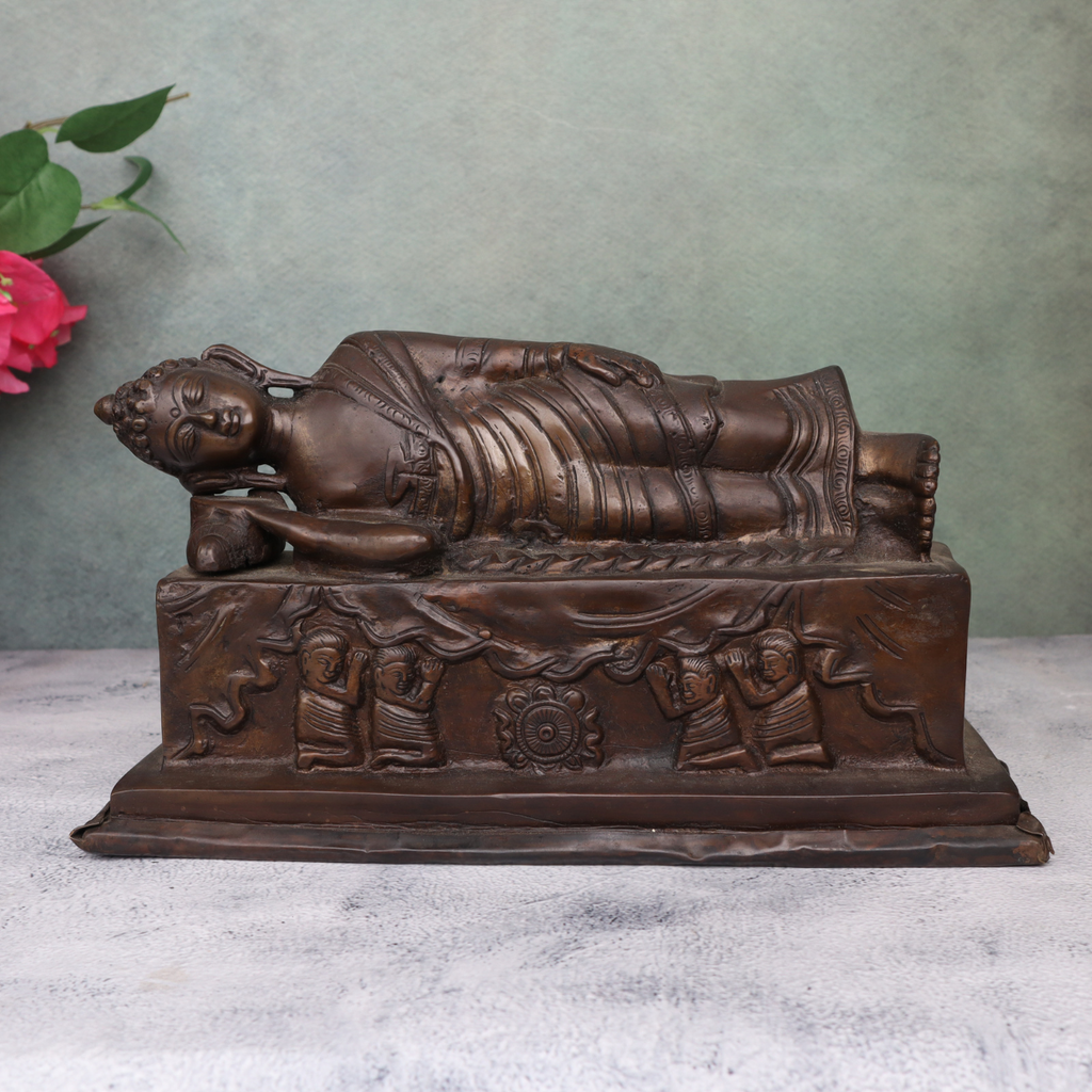 Brass antique sleeping Buddha statue showing serene reclining posture and detailed craftsmanship