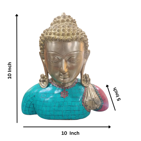 Close up view of brass Buddha idol bust showing turquoise and red stones