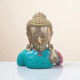 Front view of brass Buddha idol bust with turquoise and red stone work.