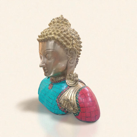 Left angle view of a brass Buddha idol bust with detailed stone inlay.