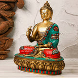 Left angle view of a brass Buddha Murti in colorful mosaic work.