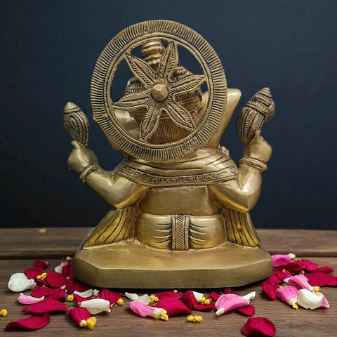 Back view of brass Ganesha statue with Shankh in hand highlighting smooth brass finish