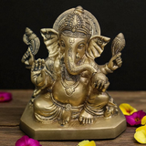 Front view of brass Ganesha statue with Shankh in hand in sitting posture, 7.5 inch