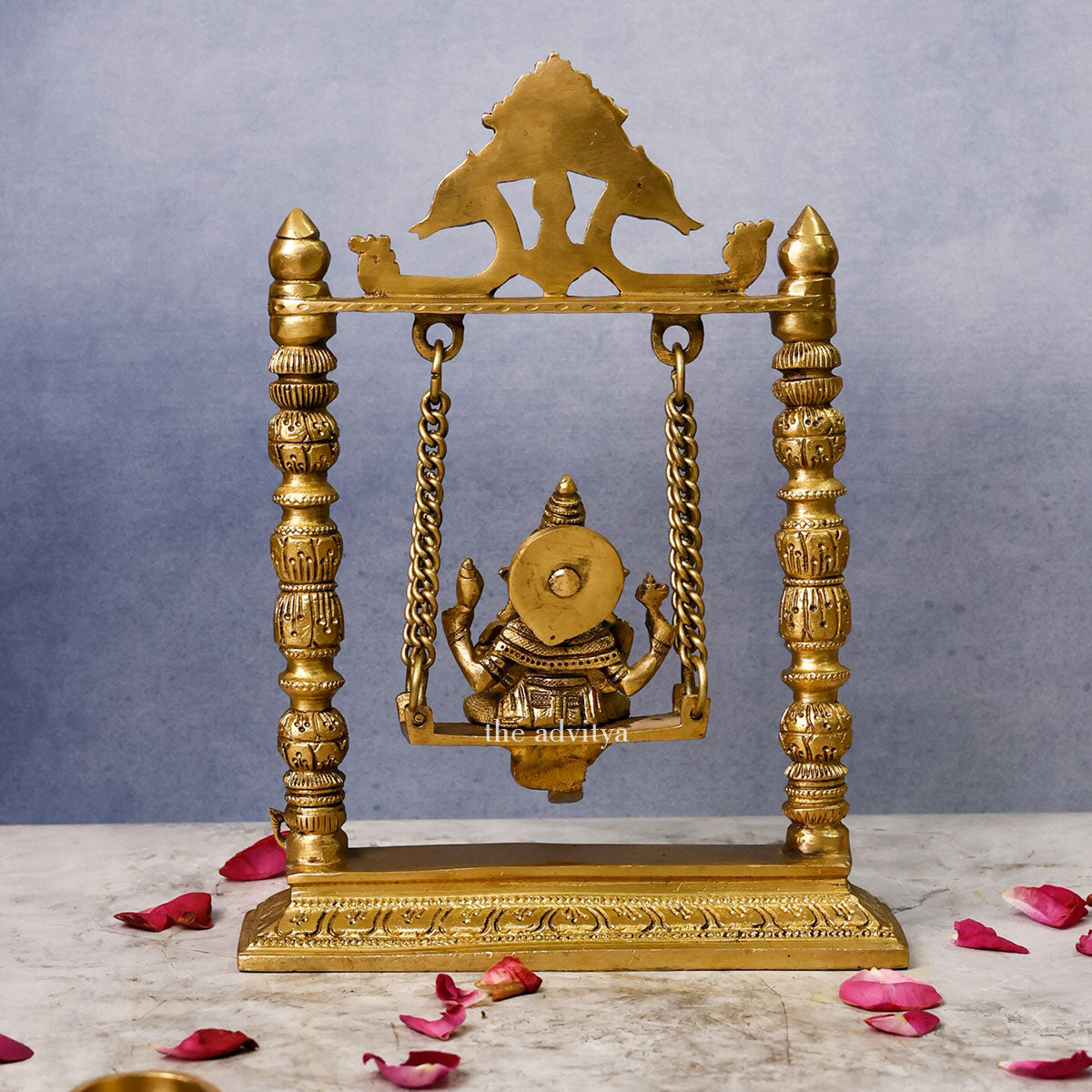 Back view of 10-inch Brass Ganpati Idol on Jhula swing, showcasing intricate design and ideal for spiritual home decoration.