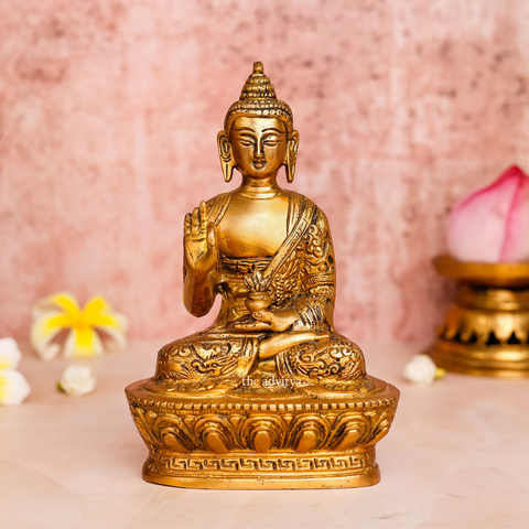 Close-up of brass handcarved Buddha Murti focusing on calm facial features and detailed crown work.