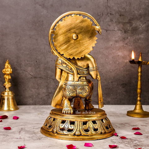 Back view of a large brass Hanuman idol in sitting posture