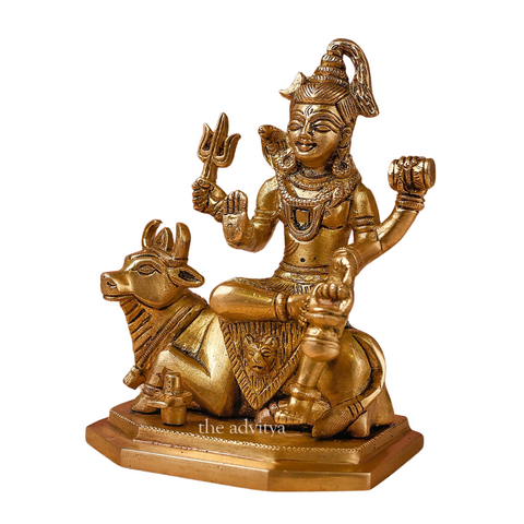 Left side angle of the brass Lord Shiva idol with Nandi, highlighting the trident and ornaments.