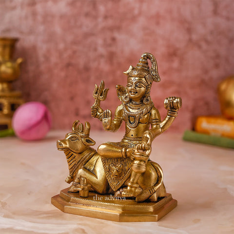 Side angle of the brass Lord Shiva idol with Nandi, highlighting the trident and ornaments.