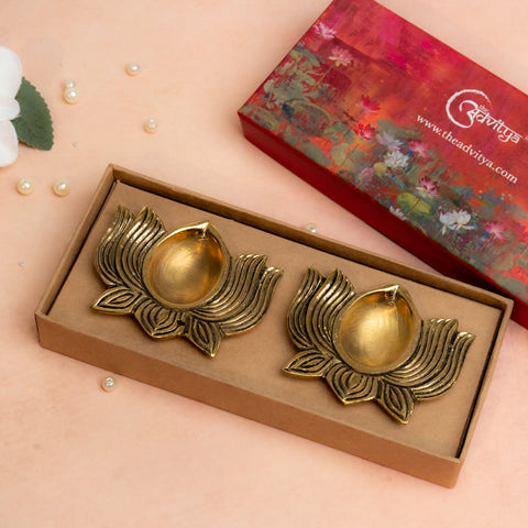 Close-up of brass lotus diya with golden tone and petal detailing.