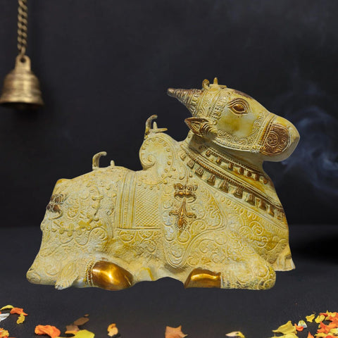 Brass Nandi idol with sand finish and golden tone placed in devotional setting
