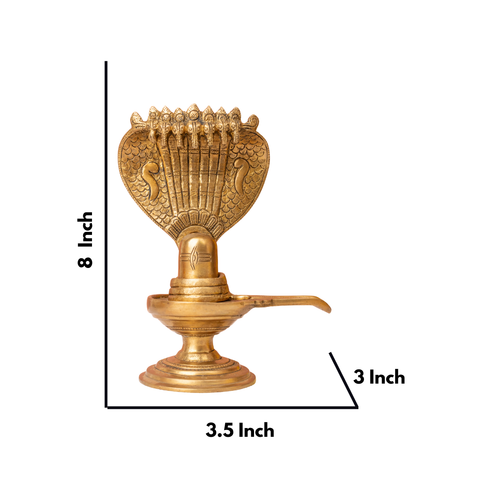 Close-up view of Brass shivling with detailed seven-headed snake hood