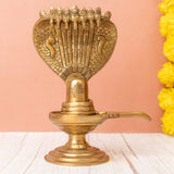 Brass shivling with a seven-headed snake on the right side angle.