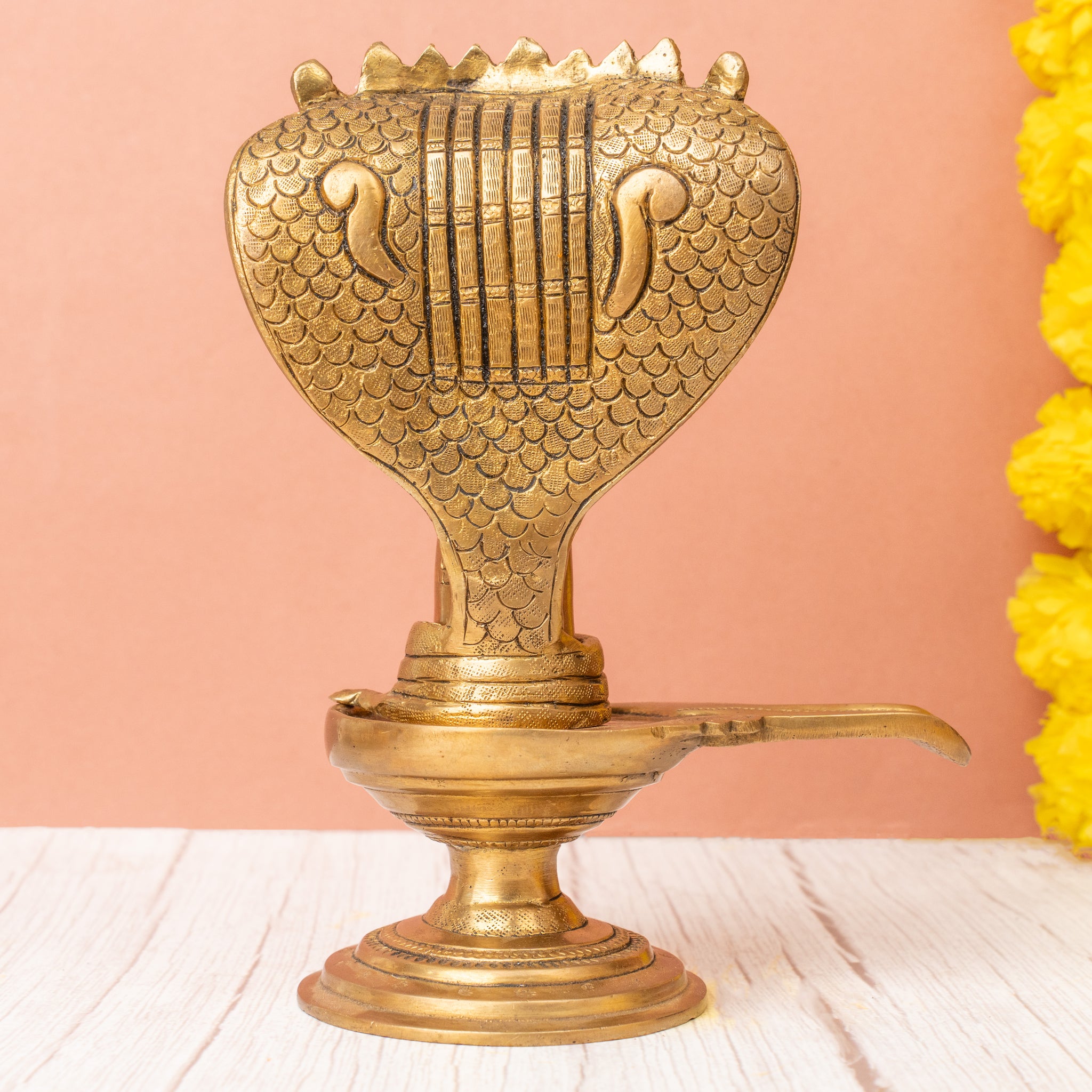 Back view of Brass shivling with seven-headed snake design.