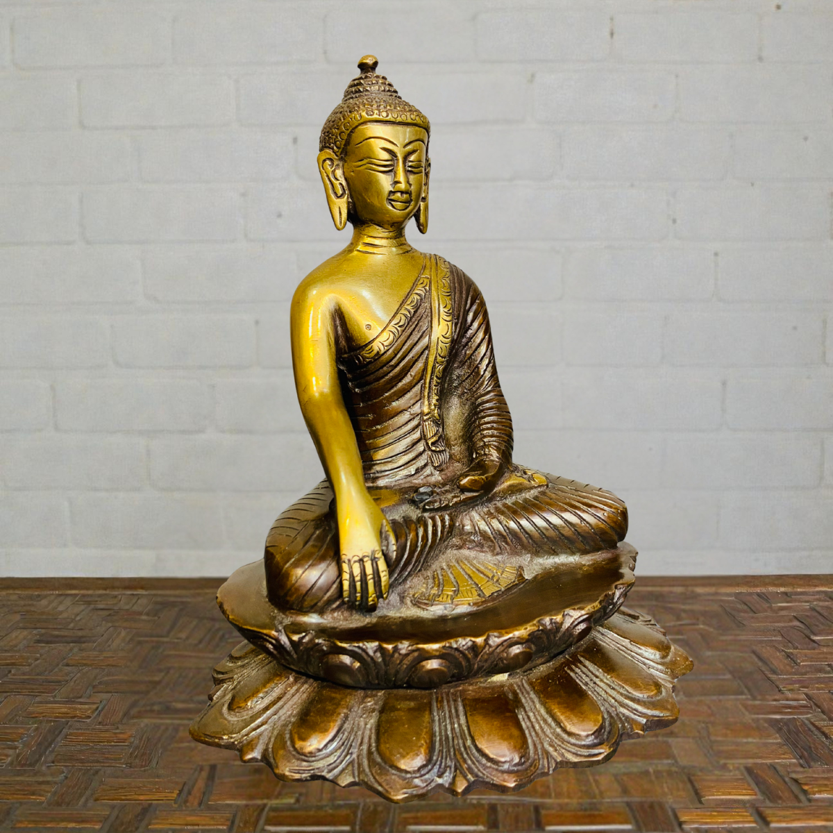 Side view of brass sitting Buddha statue for home décor