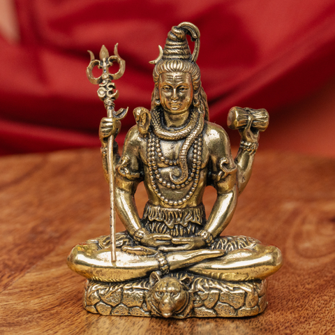 Brass Superfine Shiva idol, sitting in a front view with detailed carving.