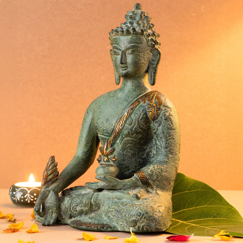 Left angle view of Brass Tibetan Buddha statue in earthy tones, highlighting textured brass surface and traditional robe details.