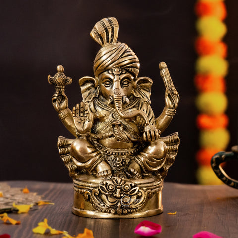 lose-up of Brass Vighnaharta Lord Ganesha idol showing fine craftsmanship and pagdi design