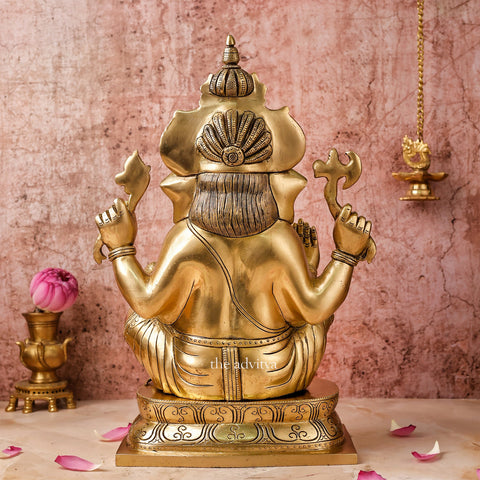 Back view of handcrafted 15.5-inch brass Ganesha statue showing detailed carvings and crown.