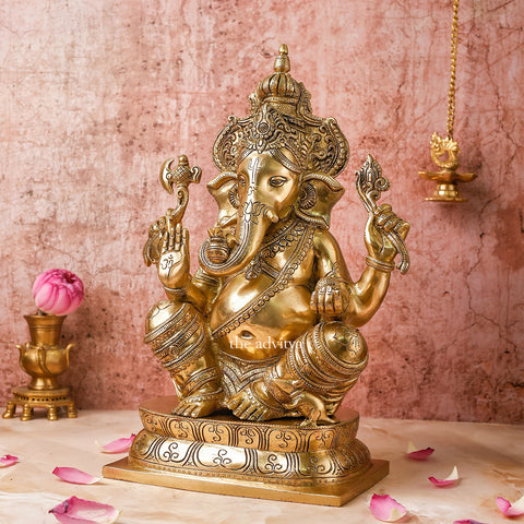 Brass Ganesha statue in sitting posture with detailed crown, ideal for gifting and spiritual décor.