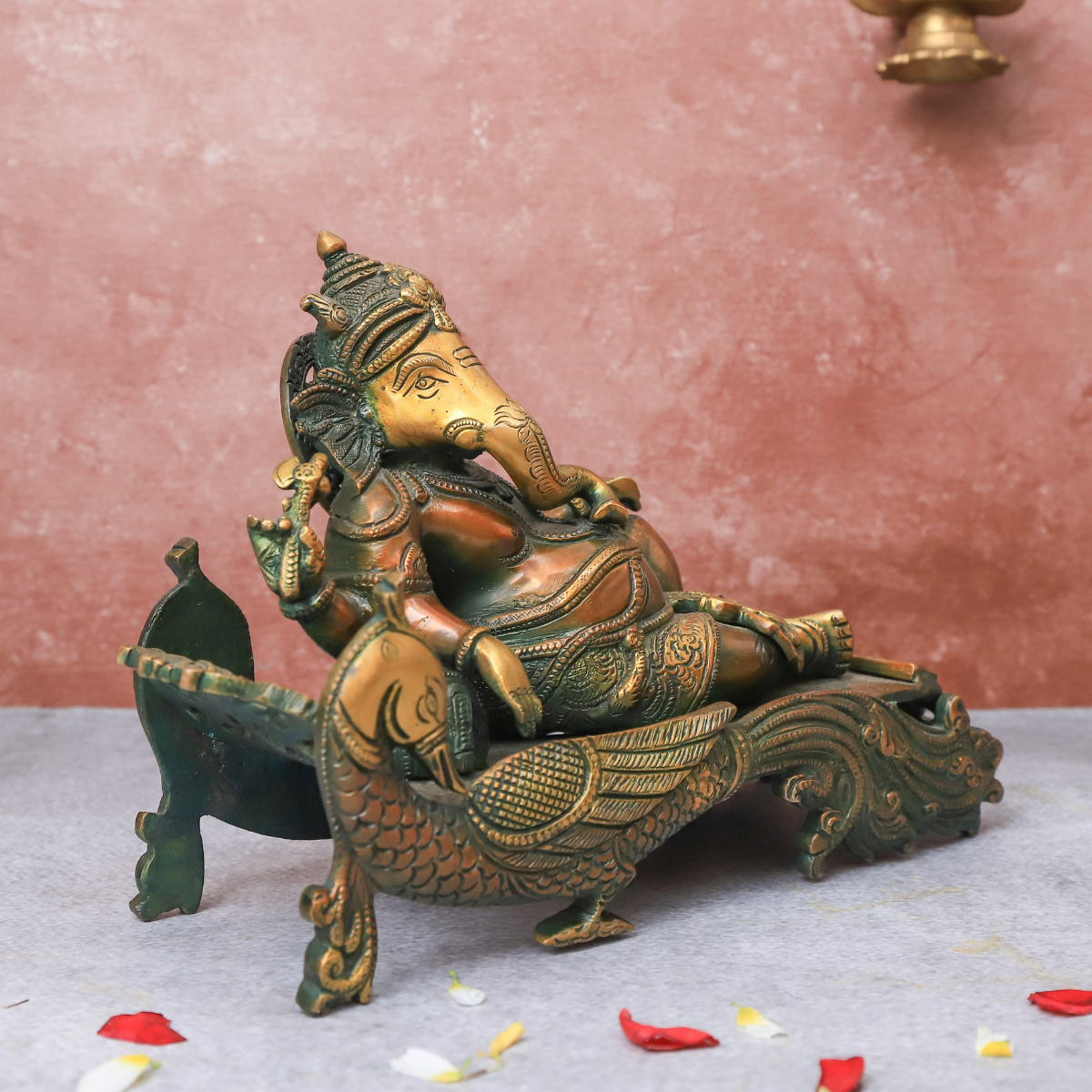 Brass Antique Ganesha resting on peacock couch