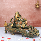 Brass Antique Ganesha resting on peacock couch