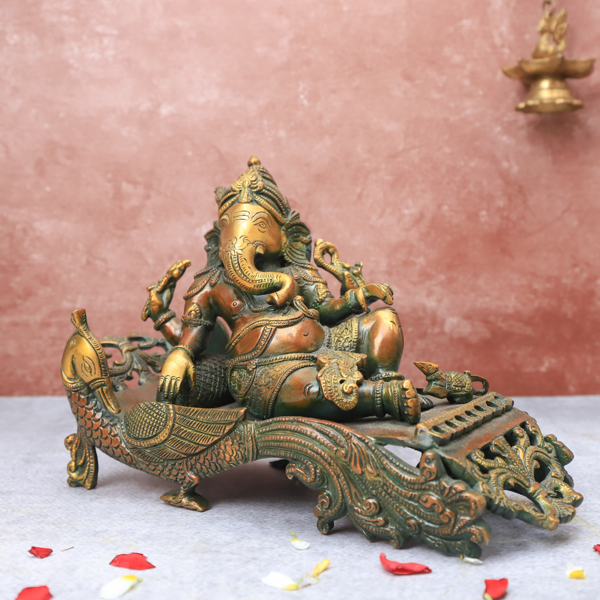 Brass Antique Ganesha resting on peacock couch