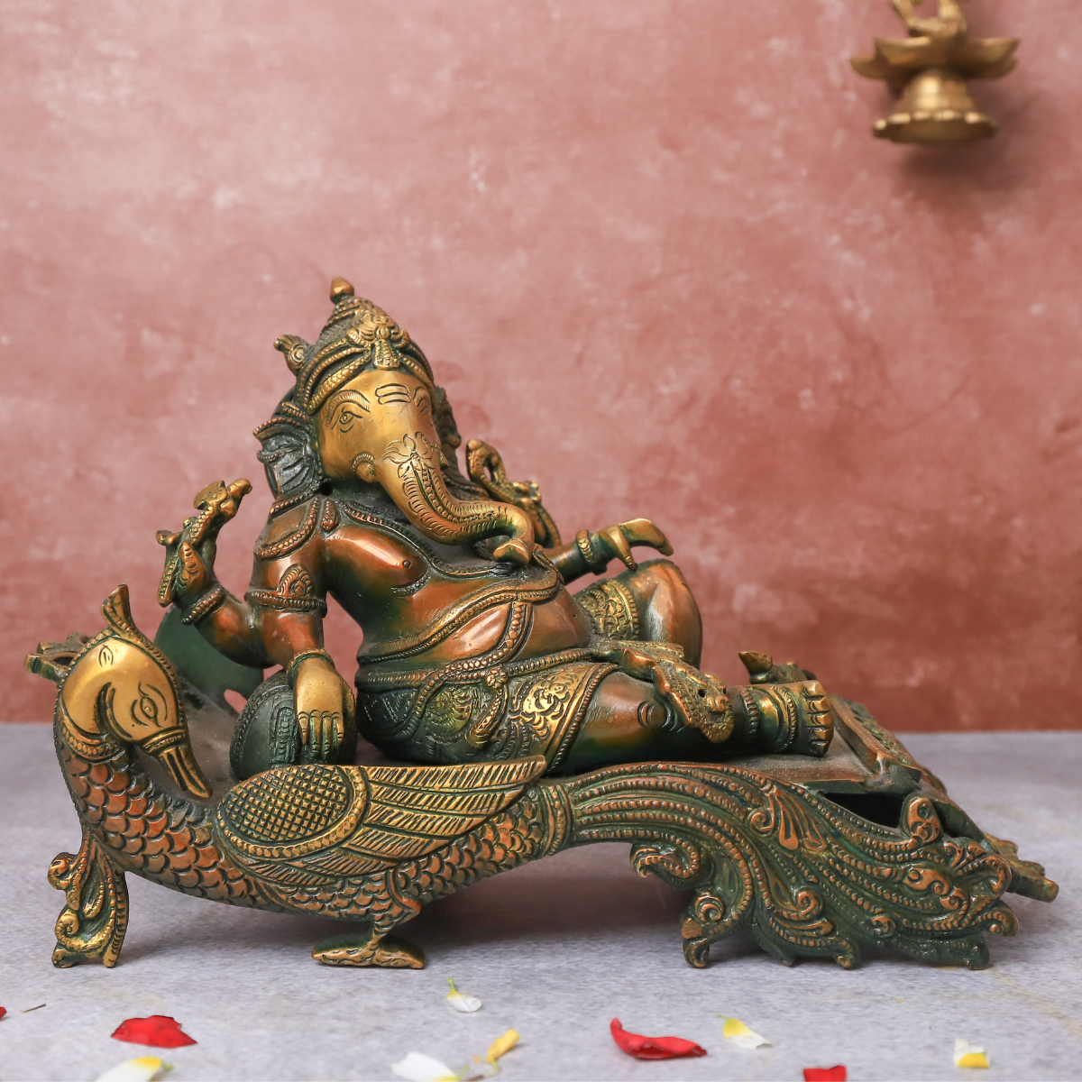 Brass Antique Ganesha resting on peacock couch