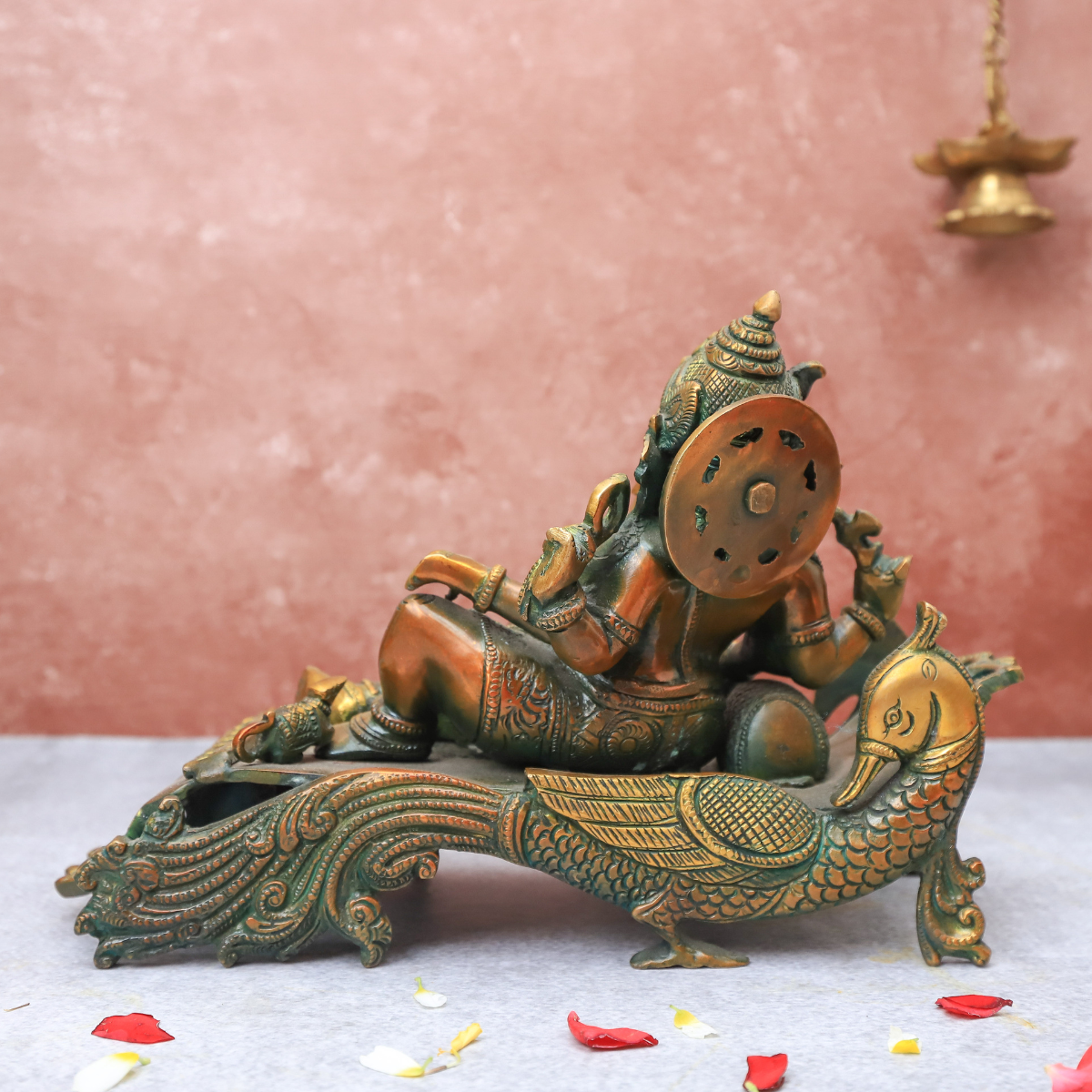 Brass Antique Ganesha resting on peacock couch