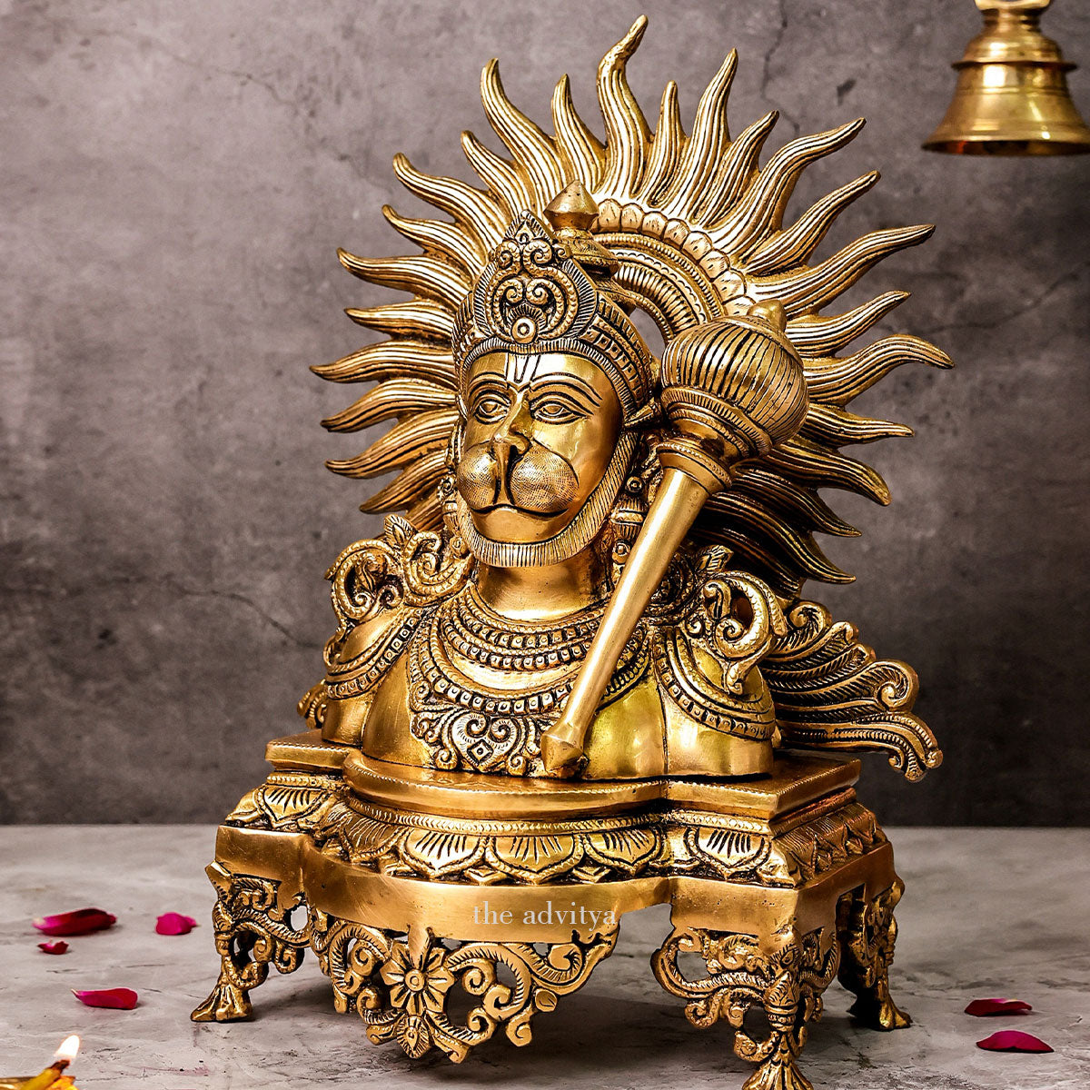 Left angle view of brass Hanuman bust idol with gada highlighting sculpted halo and traditional design