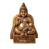 Close-up of Kuber idol holding wealth symbols with fine detailing.