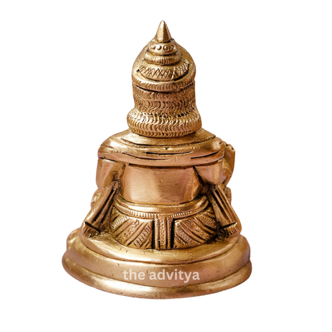 Back view of the Kubera Statue sitting on a base showing detailed finishing with a white background.