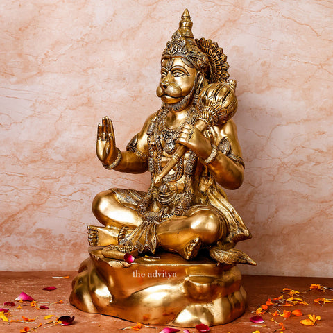 Left side angle of large brass Hanuman statue sitting with gada and blessing hand