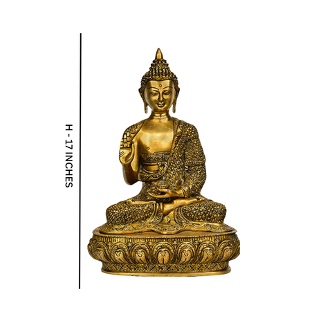 Close up view of large brass sitting Buddha statue showing intricate details.