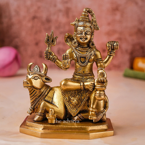 Front view of Lord Shiva idol with Nandi showing seated posture and blessing hand.